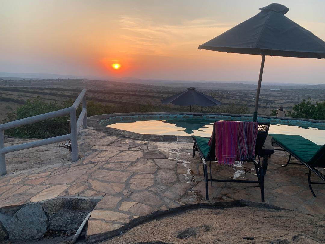 Sunset over the Ugandan hills seen from a lodge terrace